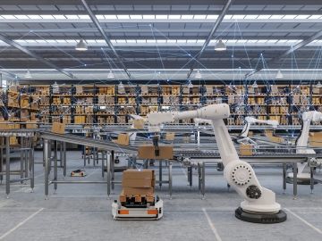 Robots lift boxes from a conveyor belt in a factory without human workers