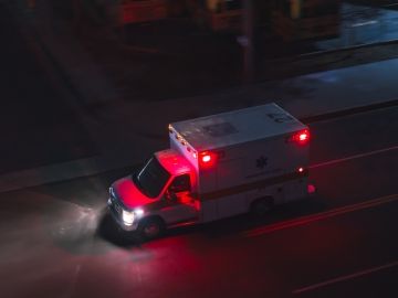 An overhead view of an ambulance driving at night.
