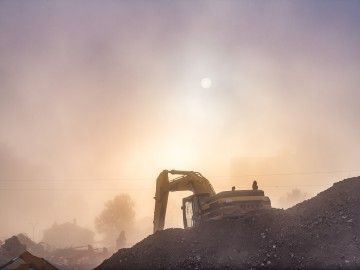 Construction equipment amid dusk and haze 