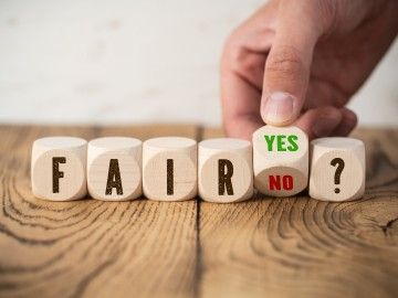 Wooden blocks spell out the words 'fair,' and 'yes or no?'
