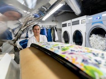 A woman works at a laundry service