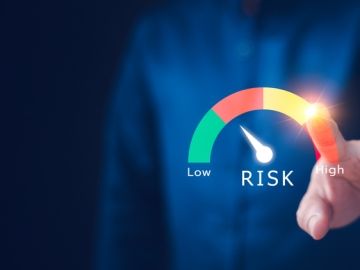 Close-up of a faceless worker indicating risk levels along a spectrum