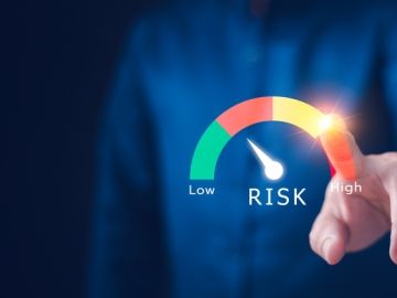 Close-up of a faceless worker indicating risk levels along a spectrum