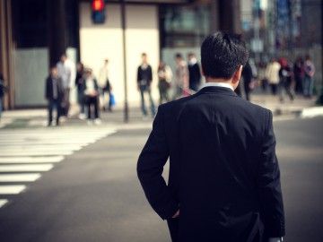 View from the back of a man in a suit in an urban street