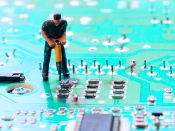 clay figure of a worker doing construction work on a motherboard