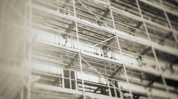 A black and white view of construction scaffolding on a building