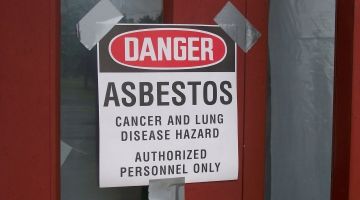 asbestos sign posted at school door