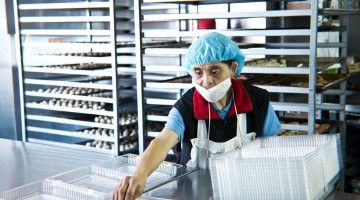 A woman with disability works in a bakery
