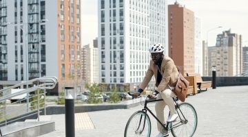 A man in a suit bikes to work