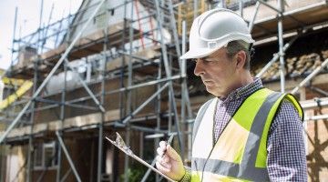 Inspector goes over checklist at construction site