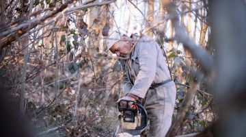 Older worker cuts wood