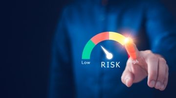 Close-up of a faceless worker indicating risk levels along a spectrum