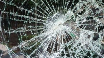 Close-up image of shattered glass window