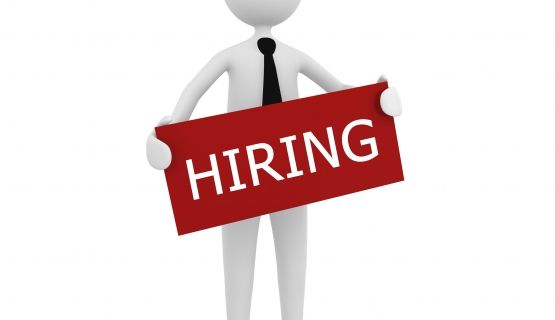 Graphic of non-descript person holding a hiring sign