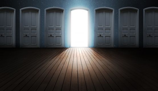 Abstract image of one open door, flanked by many closed doors