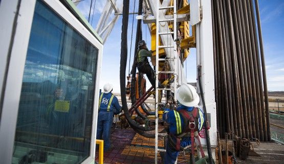 Fracking rig workers in BC climb tower