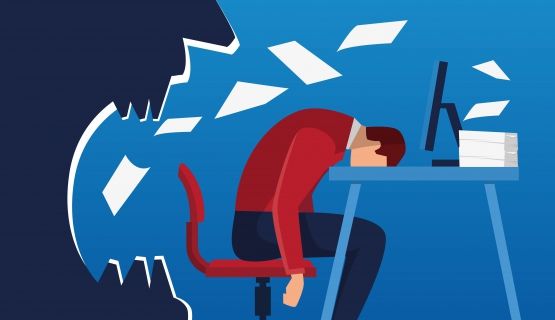 A worker slumps over in fatigue and defeat, next to an angry boss and a desk piled high with work