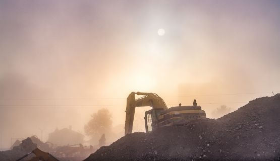 Construction equipment amid dusk and haze 