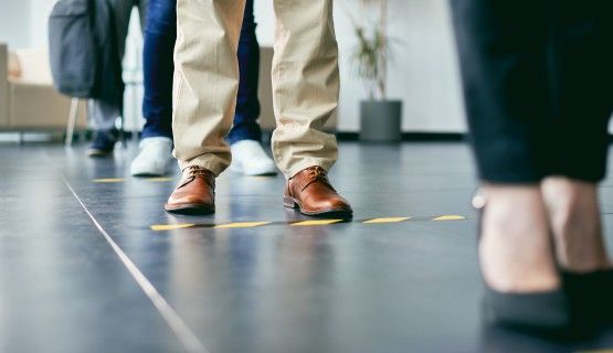 Close-up of floor markings indicating six feet distances