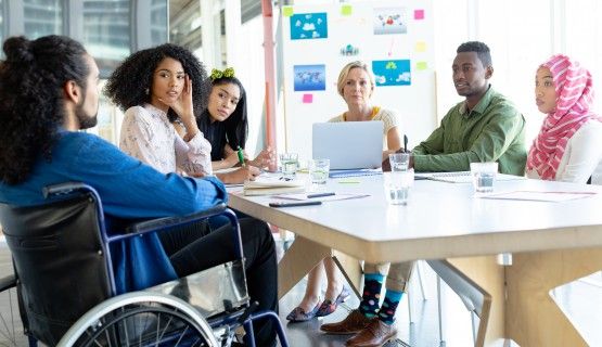 A group of people around a table, brainstorming