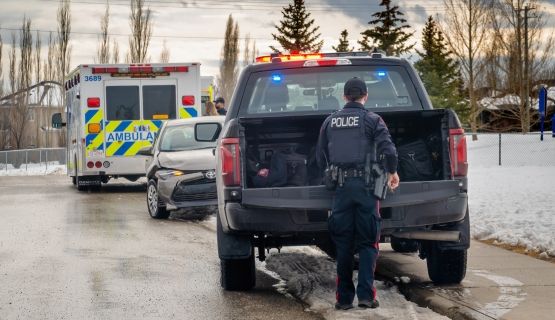 Paramedic and police vehicles at a roadside accident