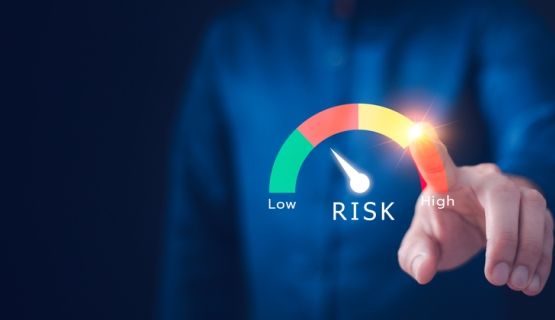 Close-up of a faceless worker indicating risk levels along a spectrum