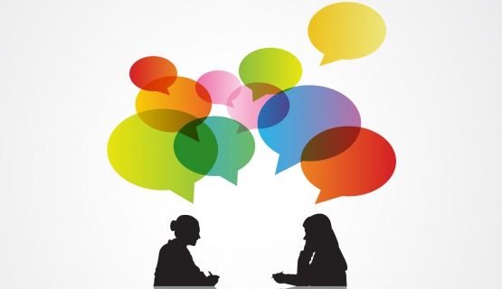 Black silhouettes of two women in dialogue, with colourful speech bubbles above them