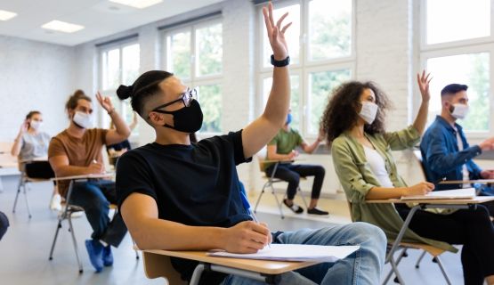Masked university students in a classroom 