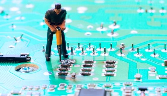 clay figure of a worker doing construction work on a motherboard