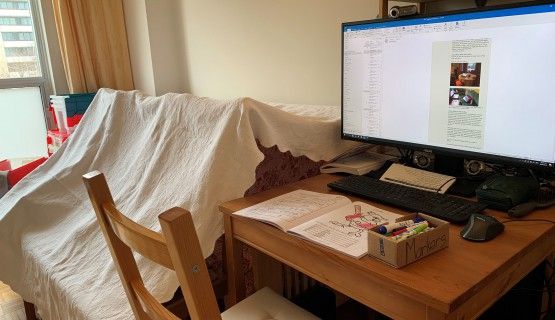 a computer workstation next to a children's tent fort