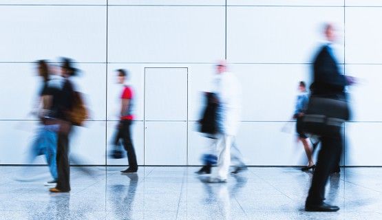 Blurred figures of workers walking