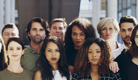 A group of young adults look into the camera